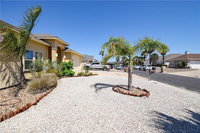 view of yard with a garage and a residential view
