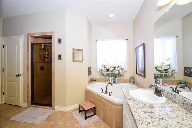 bathroom featuring a sink, a bath, a shower stall, and tile patterned floors