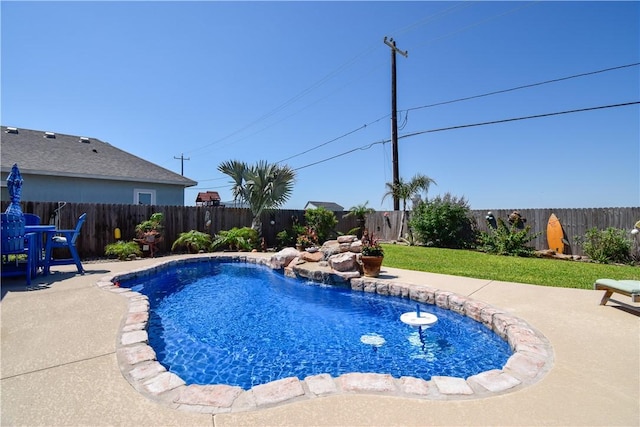 view of swimming pool with a fenced backyard and a patio area
