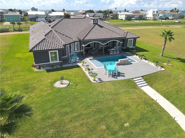 back of property with a yard and a patio