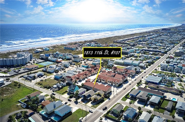 birds eye view of property featuring a water view and a view of the beach