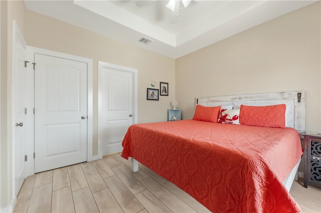 bedroom with ceiling fan and light hardwood / wood-style flooring