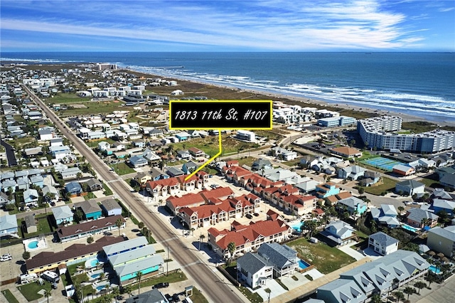 drone / aerial view featuring a water view and a view of the beach