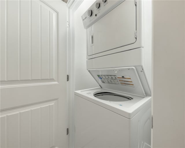 clothes washing area with stacked washer and dryer