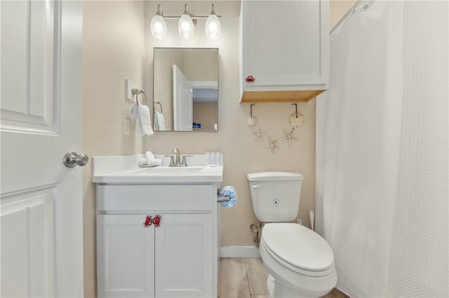 bathroom featuring hardwood / wood-style flooring, vanity, and toilet