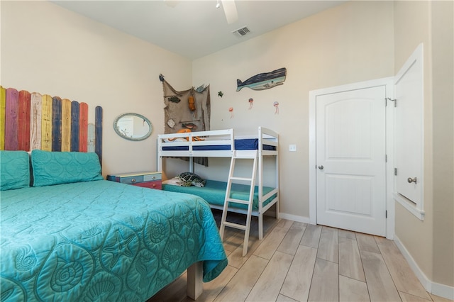 bedroom with ceiling fan and hardwood / wood-style flooring