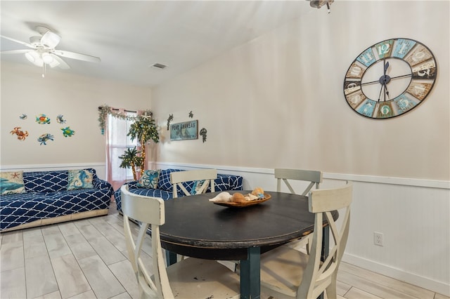 dining room with light wood-type flooring and ceiling fan