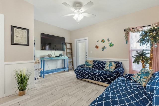 living room featuring wood-type flooring and ceiling fan