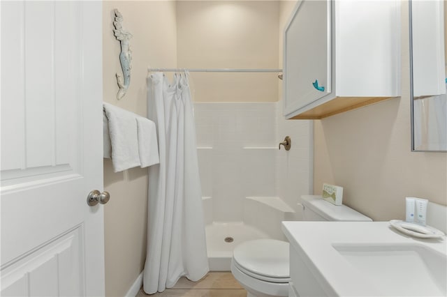 bathroom with tile patterned floors, curtained shower, sink, and toilet