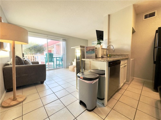 kitchen featuring dishwashing machine, a sink, visible vents, white cabinetry, and open floor plan