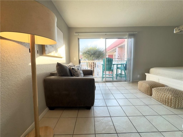 living area featuring light tile patterned floors and baseboards