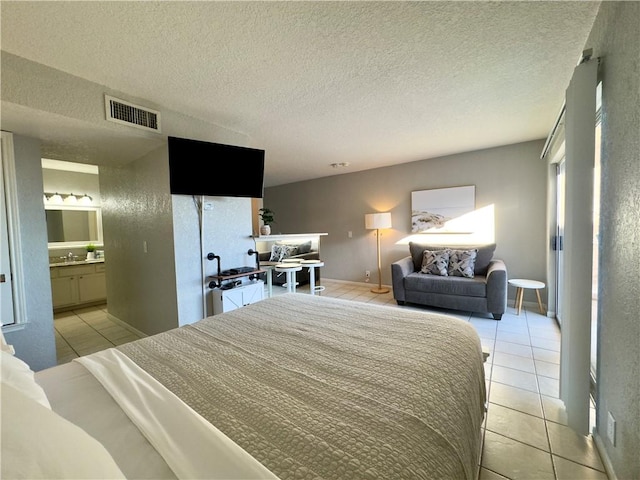 bedroom featuring visible vents, a textured ceiling, and light tile patterned flooring