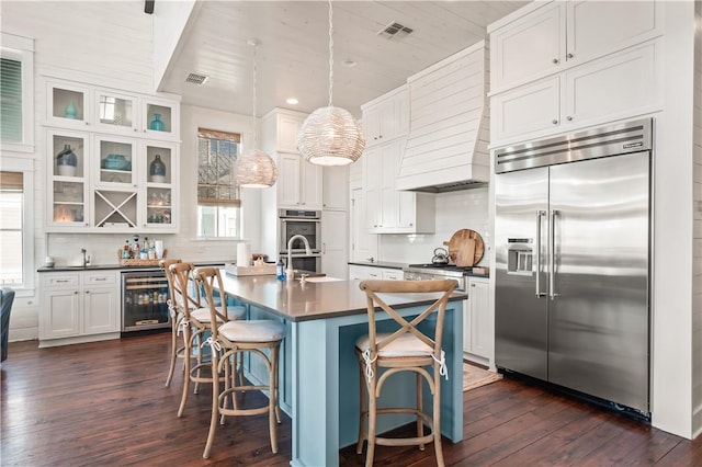 kitchen featuring wine cooler, dark wood-type flooring, visible vents, white cabinetry, and appliances with stainless steel finishes