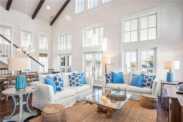 living area featuring french doors, stairway, wood finished floors, high vaulted ceiling, and beamed ceiling