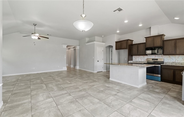 7525 Killebrew Dr, Corpus Christi, TX 78414 - kitchen featuring stainless steel electric range oven, black microwave, lofted ceiling, decorative backsplash, and open floor plan