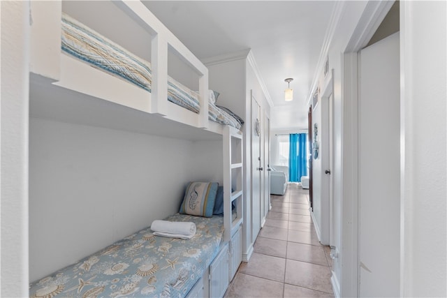 corridor featuring light tile patterned floors and ornamental molding