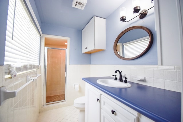 bathroom featuring toilet, an enclosed shower, tile walls, vanity, and tile patterned flooring