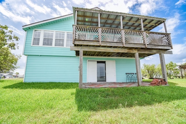 rear view of property with a yard and a patio