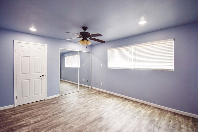 unfurnished bedroom with hardwood / wood-style flooring and ceiling fan