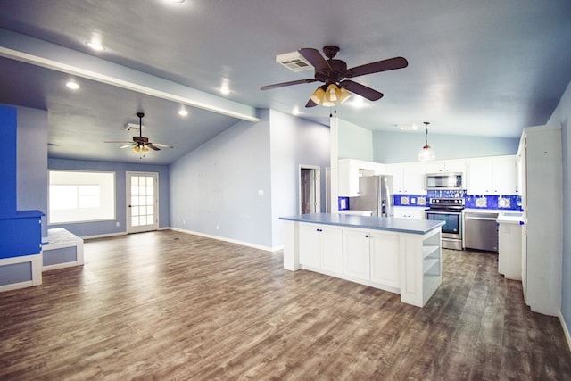 kitchen with white cabinetry, backsplash, dark hardwood / wood-style flooring, hanging light fixtures, and stainless steel appliances