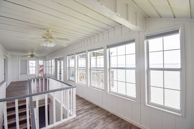 unfurnished sunroom featuring vaulted ceiling, ceiling fan, and wood ceiling