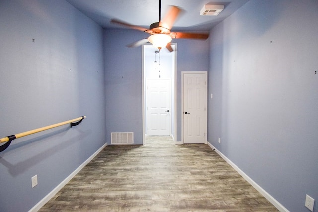 empty room with hardwood / wood-style floors and ceiling fan