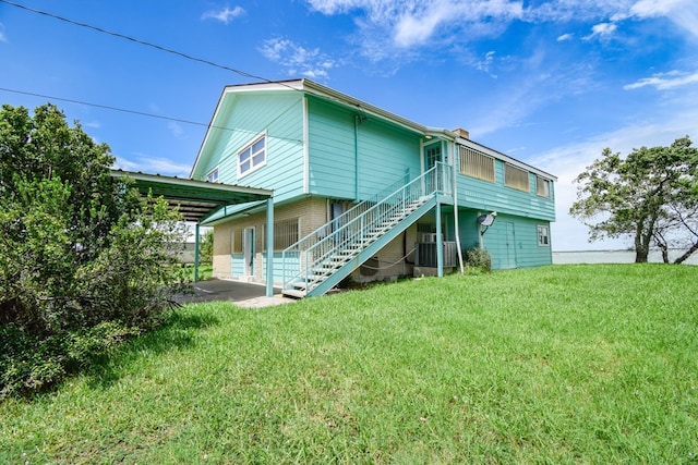 back of house featuring cooling unit and a lawn