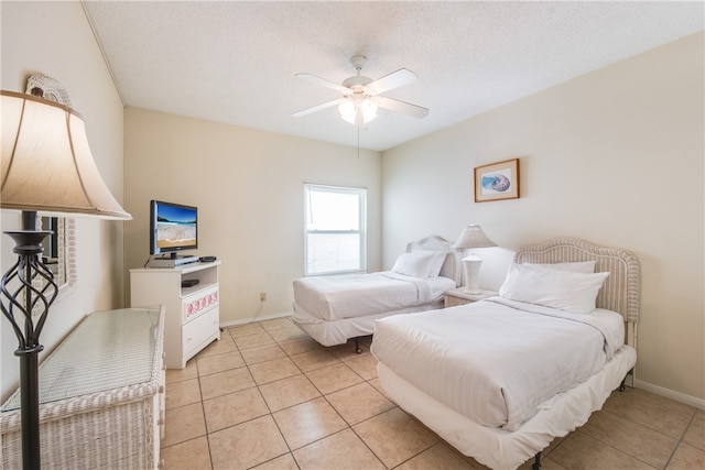 tiled bedroom featuring a textured ceiling and ceiling fan