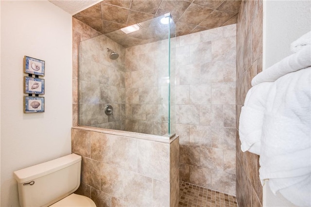 bathroom featuring walk in shower and toilet