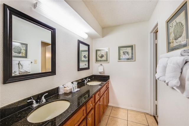full bath featuring tile patterned flooring, double vanity, and baseboards