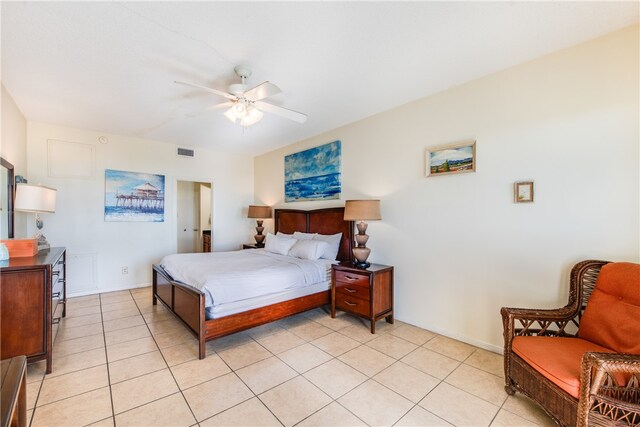 tiled bedroom featuring ceiling fan