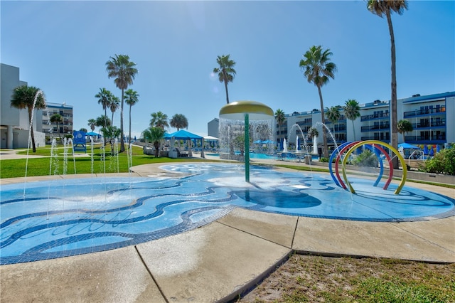 view of pool with a lawn