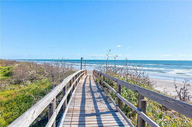 view of property's community with a beach view and a water view