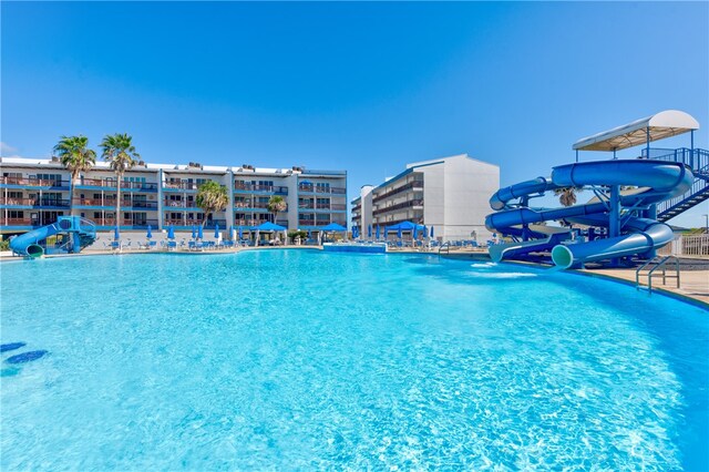 view of swimming pool featuring a water slide