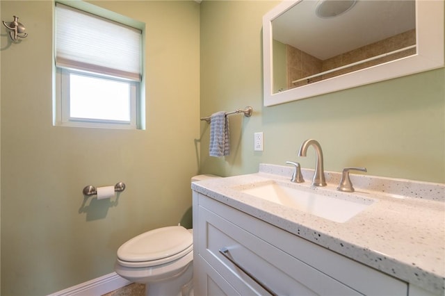 bathroom featuring toilet and vanity