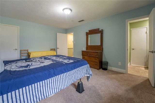 bedroom with visible vents, baseboards, and carpet flooring