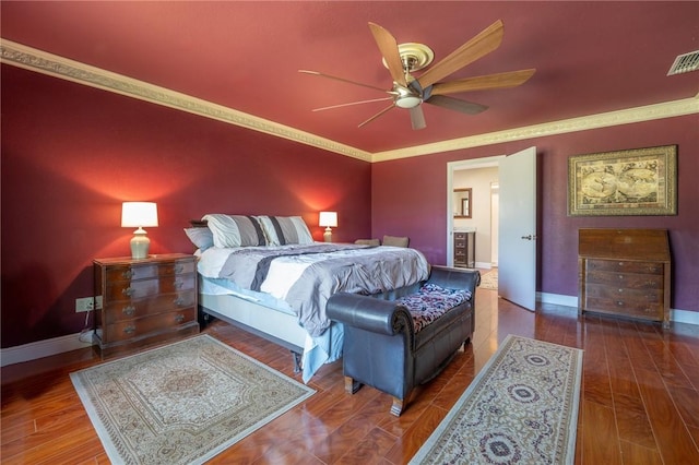 bedroom featuring baseboards, crown molding, and wood finished floors