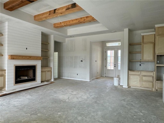 unfurnished living room with a fireplace and beamed ceiling