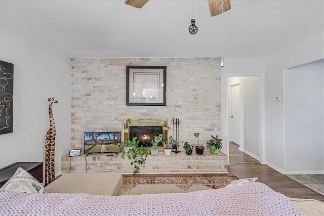 living room featuring a fireplace, ceiling fan, and hardwood / wood-style flooring