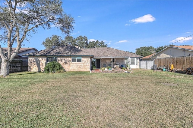 back of property featuring a yard