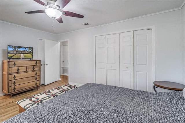 bedroom with ornamental molding, ceiling fan, hardwood / wood-style flooring, and a closet