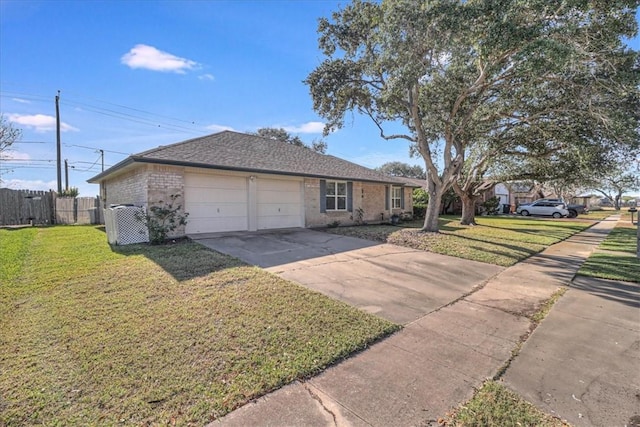 ranch-style home featuring a garage and a front lawn