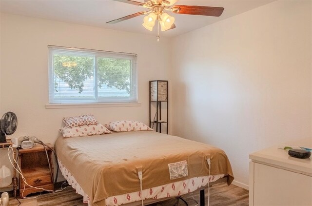 bedroom with hardwood / wood-style floors and ceiling fan