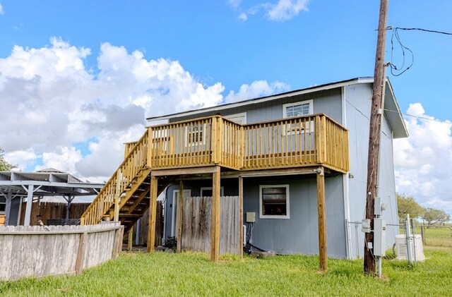 back of property featuring a yard and a deck