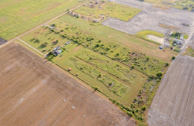 birds eye view of property with a rural view