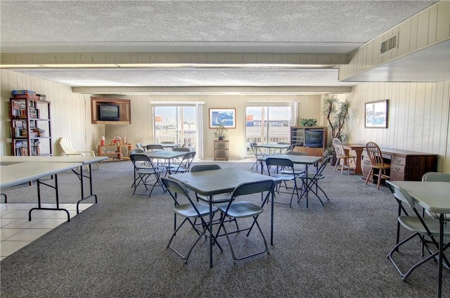 14300 S Padre Island Dr Unit 79, Corpus Christi, TX 78418 - dining room with a textured ceiling, wood walls, and carpet floors