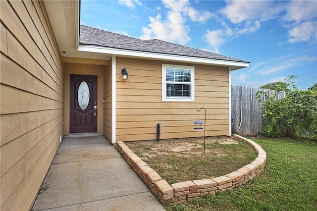 entrance to property with a lawn