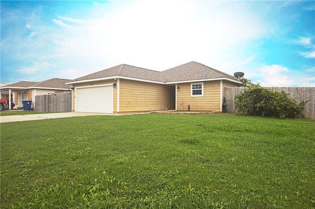 ranch-style house featuring a garage and a front lawn