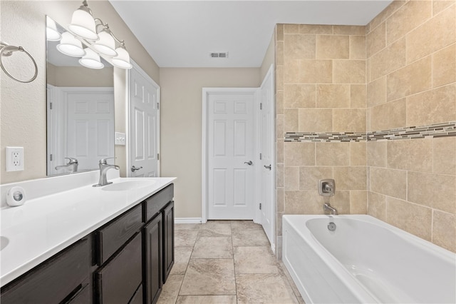 bathroom with vanity and tiled shower / bath combo