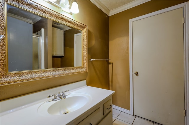 bathroom featuring tile patterned flooring, vanity, and crown molding